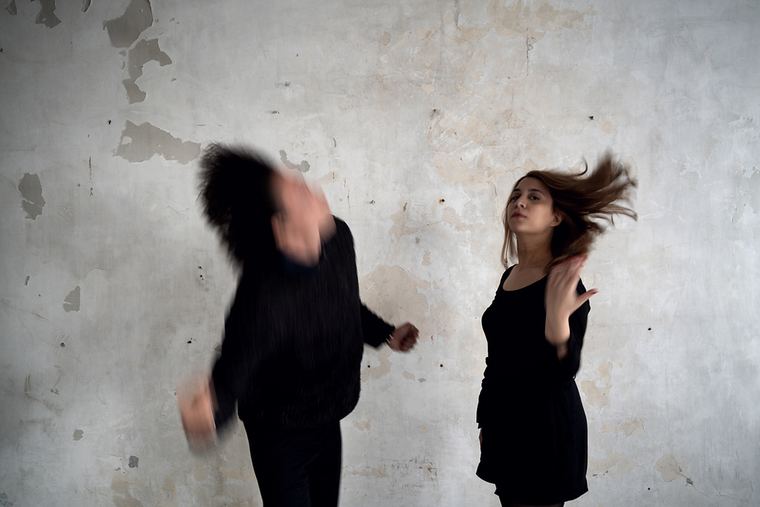 Both players turning, heads blurred with motion.
