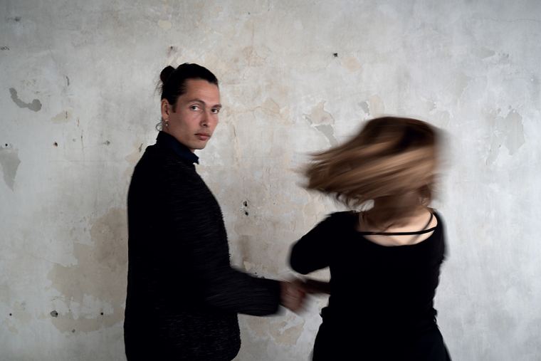 Hair caught mid-motion in front of the wall.