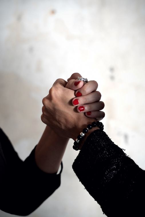 Macro view of the grip between two hands.
